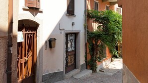 A narrow cobblestone street with a wrought iron gate and a door with decorative ironwork. - 'Casa Vacanza Malva' Apartment with Wi-Fi (Baveno)