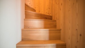 Un escalier en bois, doté d’une rampe, menant à l’étage supérieur.