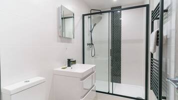 Shower, hair dryer, towels, shampoo
