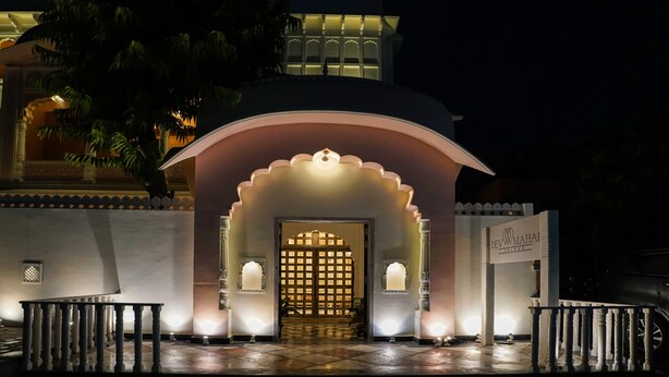 A traditional entrance with an arched doorway, a tiled floor, and a signboard. - Dev Mahal - A Boutique Heritage Hotel (Jaipur)