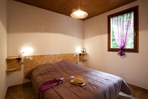 Relax in this serene bedroom with a large bed, wooden headboard, and a window with a view.