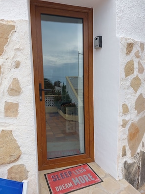 Secure entrance with a glass panel door and a discreet security device.