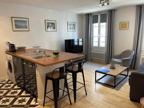 A compact living space with a kitchenette, a dining area, and a seating area.