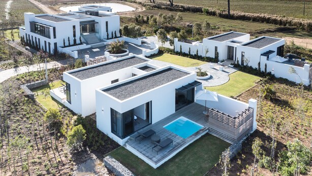 Una casa moderna con una gran piscina, varias habitaciones y un jardín bien cuidado.