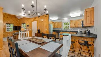 Kitchen features new countertops and stainless steel appliances.