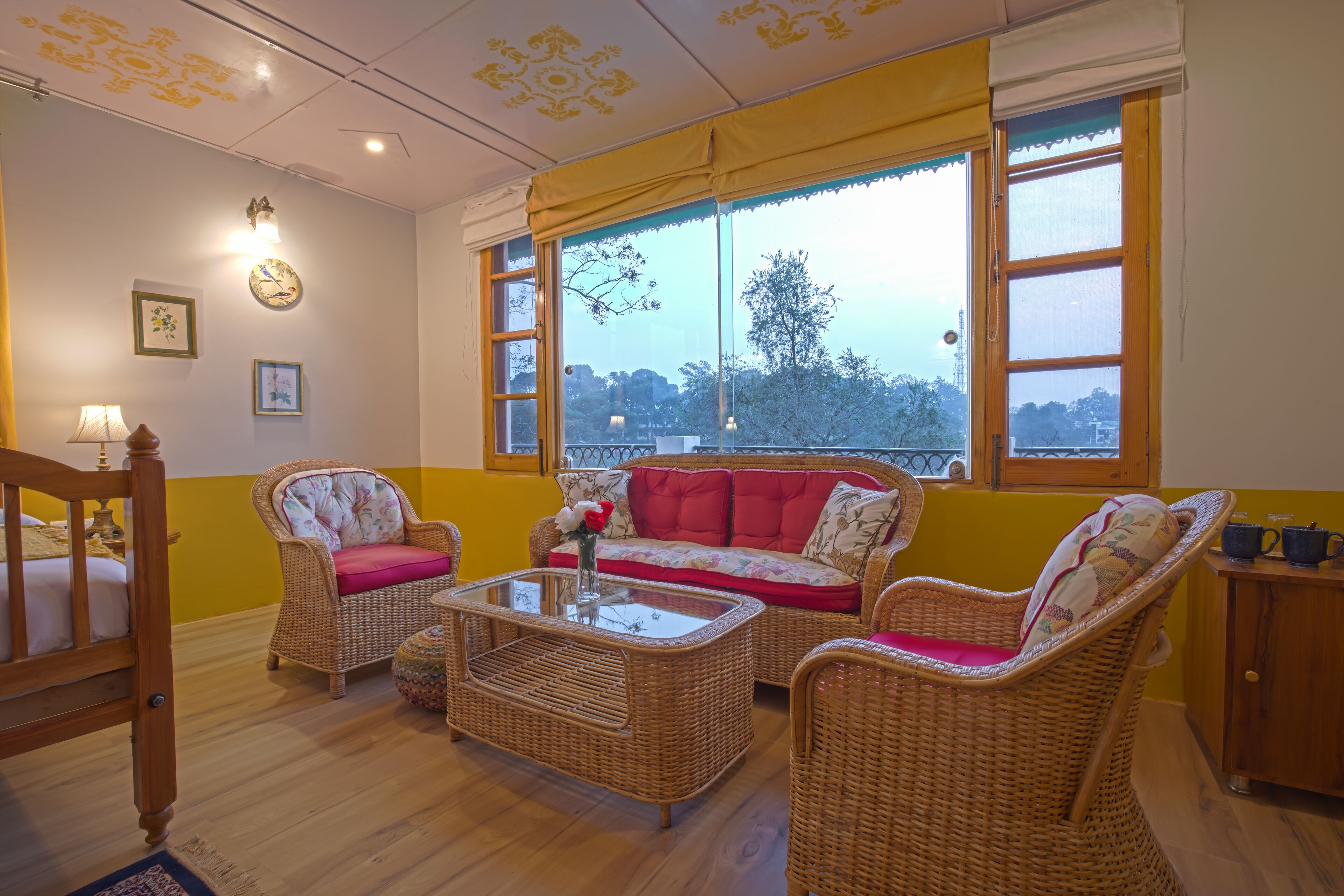 A cozy room with wicker furniture, a sofa, and a glass coffee table.