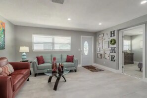 Relax in this inviting living space with a comfortable sofa, coffee table, and decorative accents.