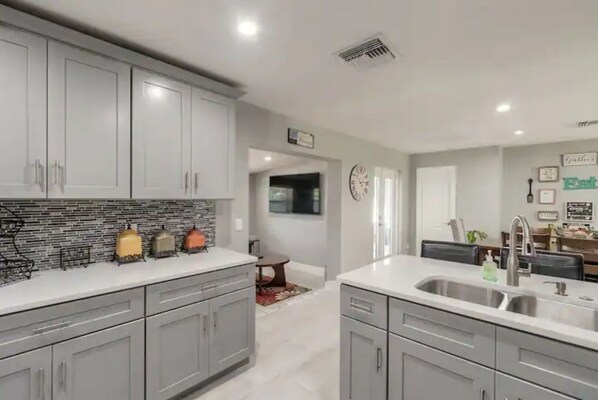 Enjoy meals in the well-lit kitchen with a central island and dining area.