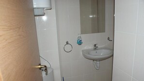 A bathroom with a toilet, sink, and mirror. - Beautiful 1-bed Studio in Sunny Beach Bulgaria (Nessebar)