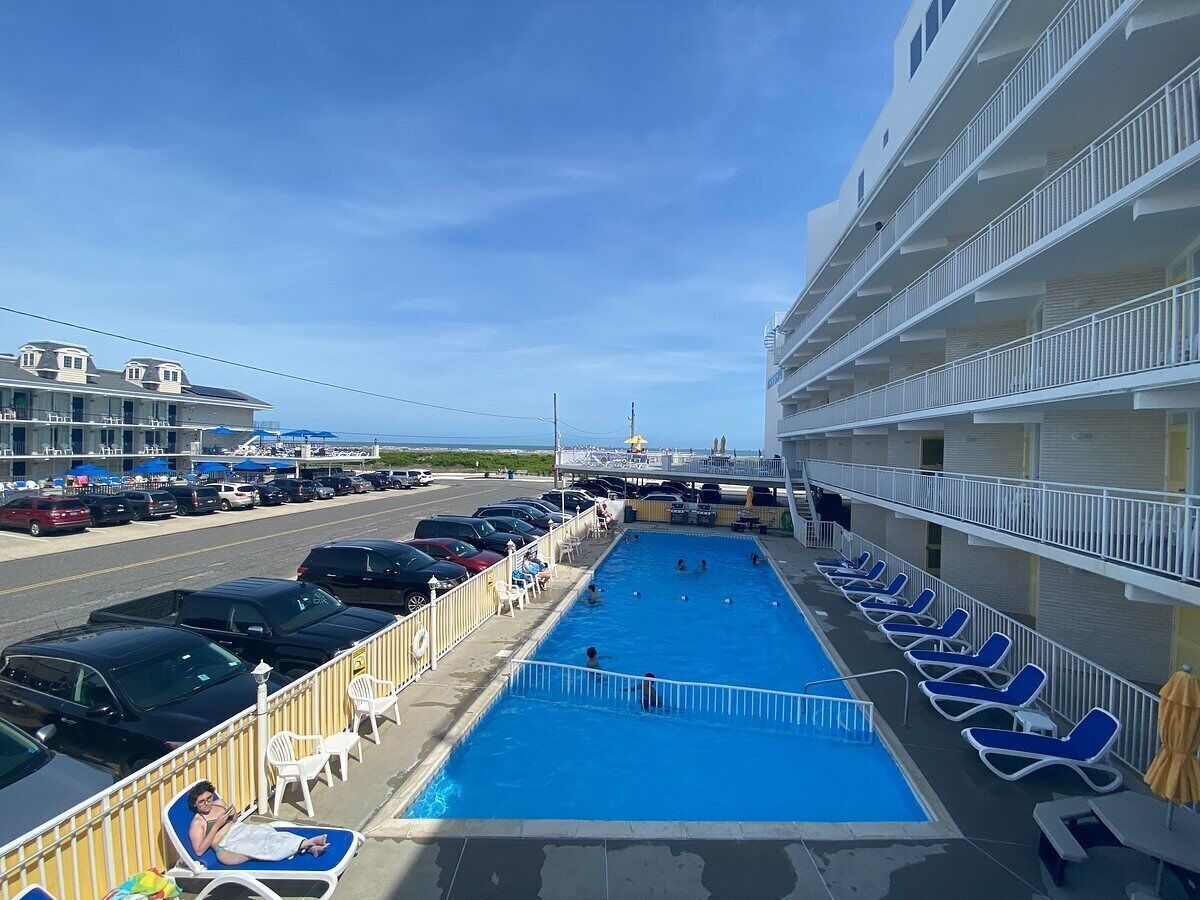 A pool area with lounge chairs and a swimming pool on a cruise ship deck.