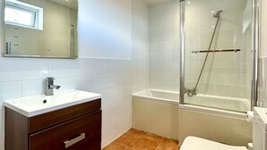 A modern bathroom with a vanity, sink, mirror, shower, and toilet. - Incredible Panoramic Sea View 2 Bedroom Sleeps 4 WOW! (bournemouth)