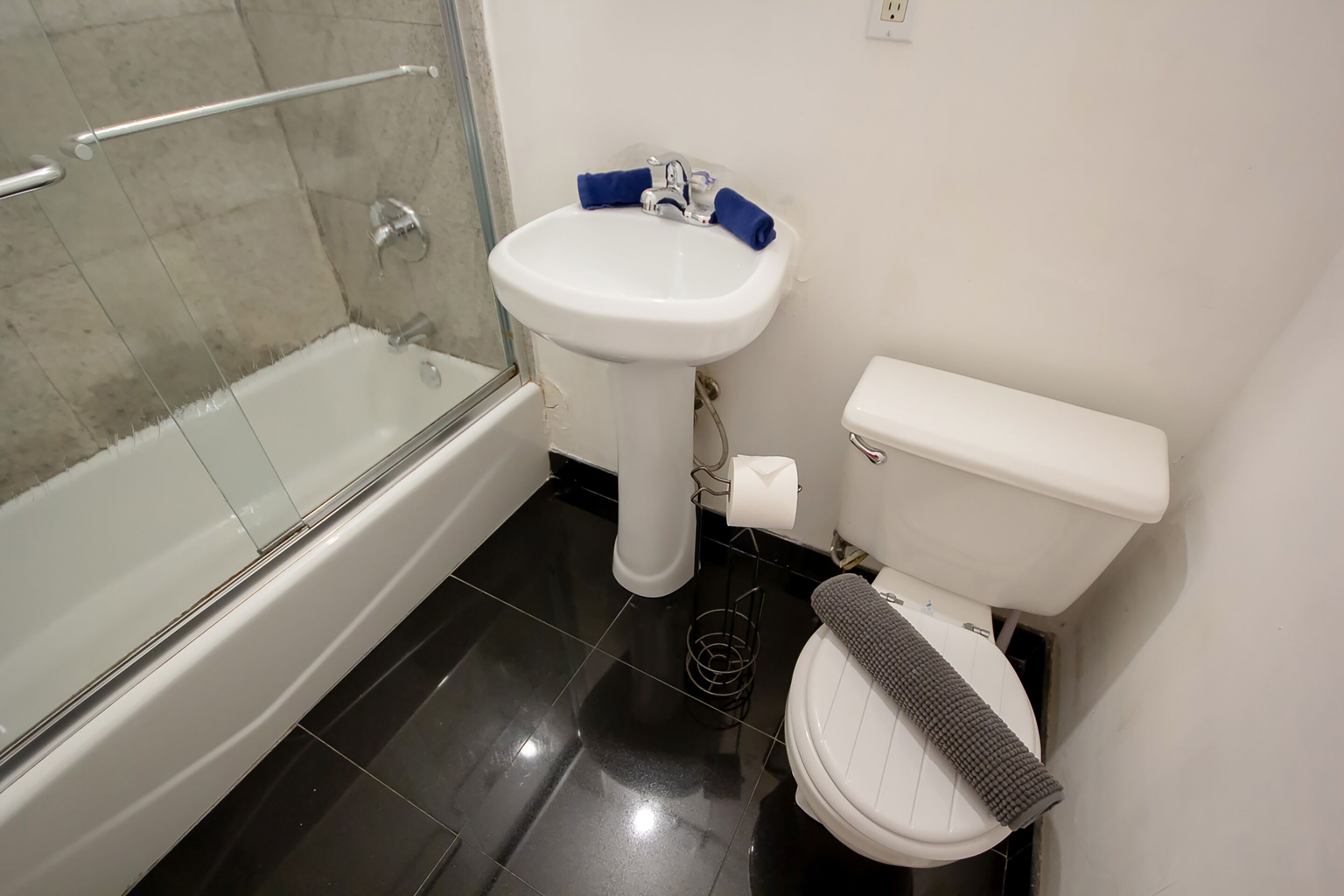 A bathroom with a bathtub, a sink, and a toilet.