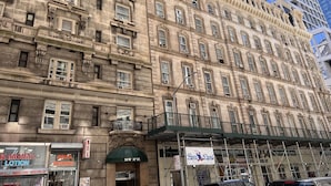 A historic building with ornate architectural details, including multiple balconies and large windows. - JGSTAY - Koreatown (New York)