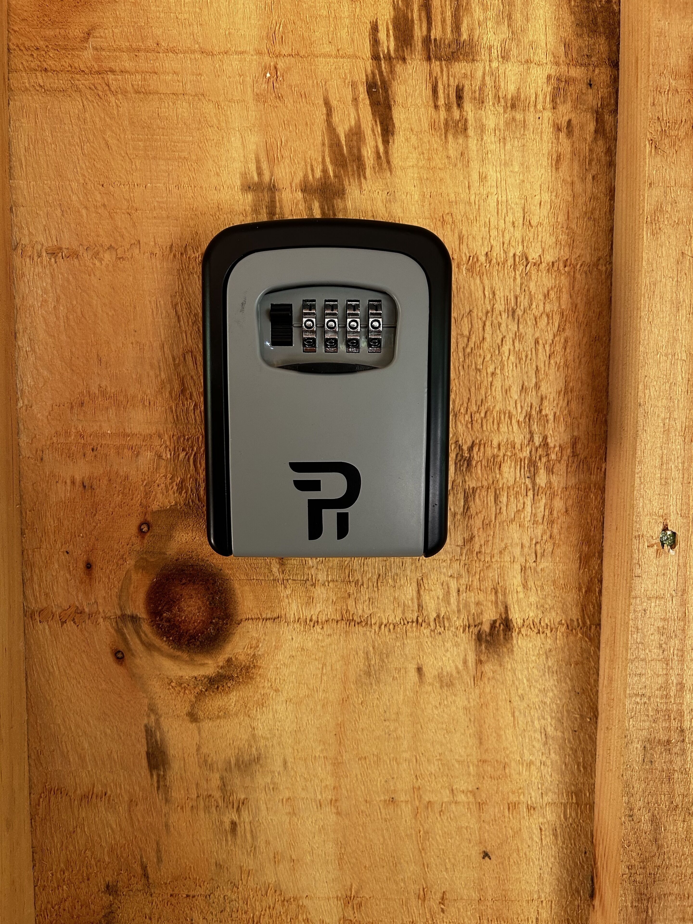 A keypad lock on a wooden surface.