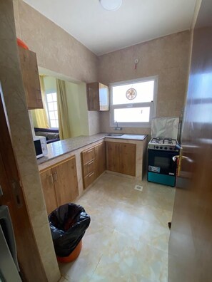 Full-sized fridge, oven, cookware/dishes/utensils, dining tables