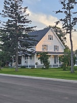 A two-story house with a porch and a covered front porch area.