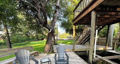 Cozy waterfront camp with dock and boat slip. Multiple outdoor spaces to enjoy!