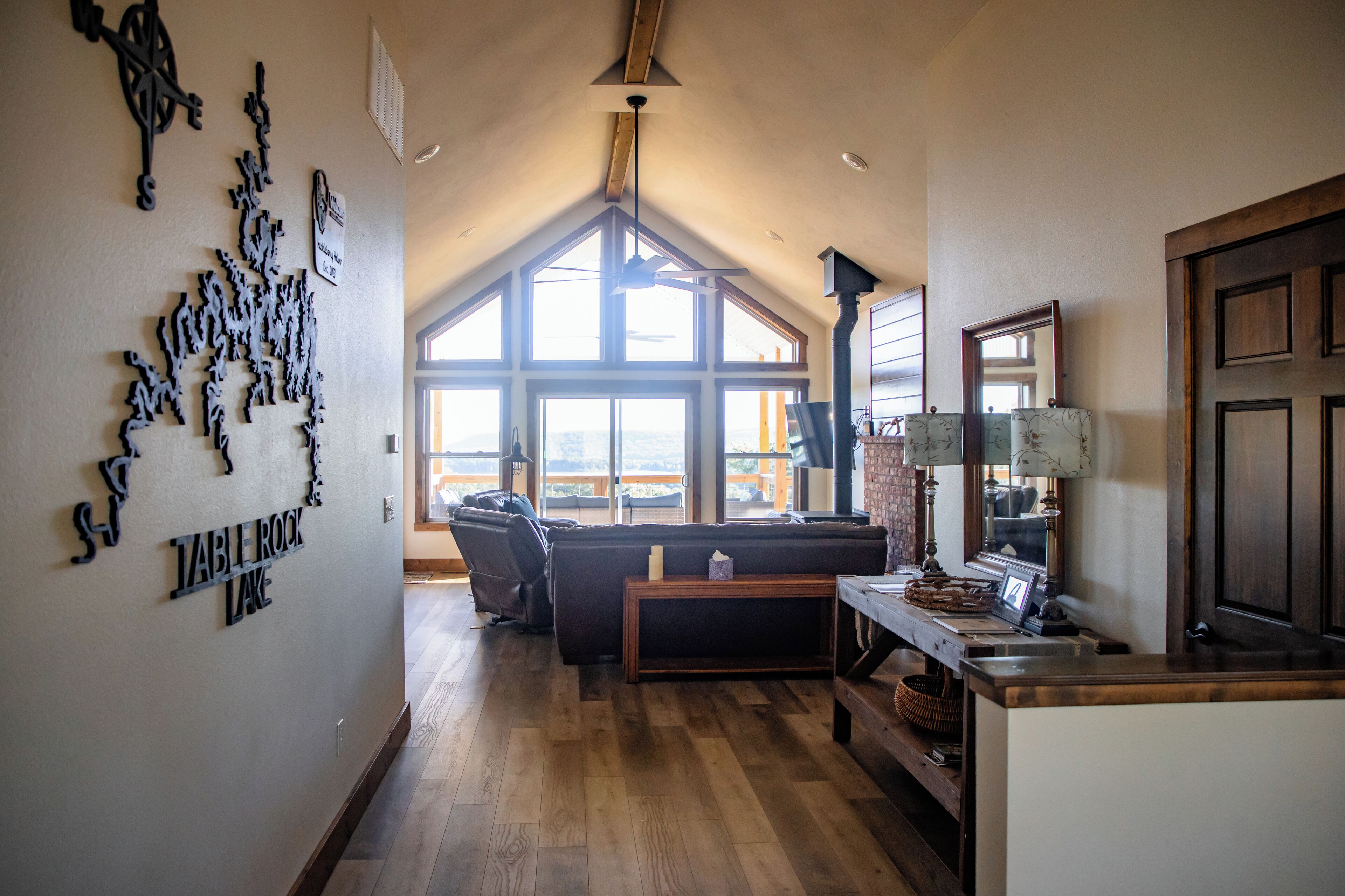 A spacious living area with a large window, a fireplace, and a cozy seating arrangement.