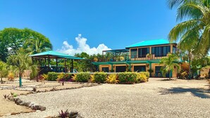 A resort with a pool, covered seating areas, and a well-maintained garden.