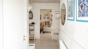 A hallway with a white door, a white radiator, and a white bench. - Stunning home in Höganäs with WiFi (Höganäs)