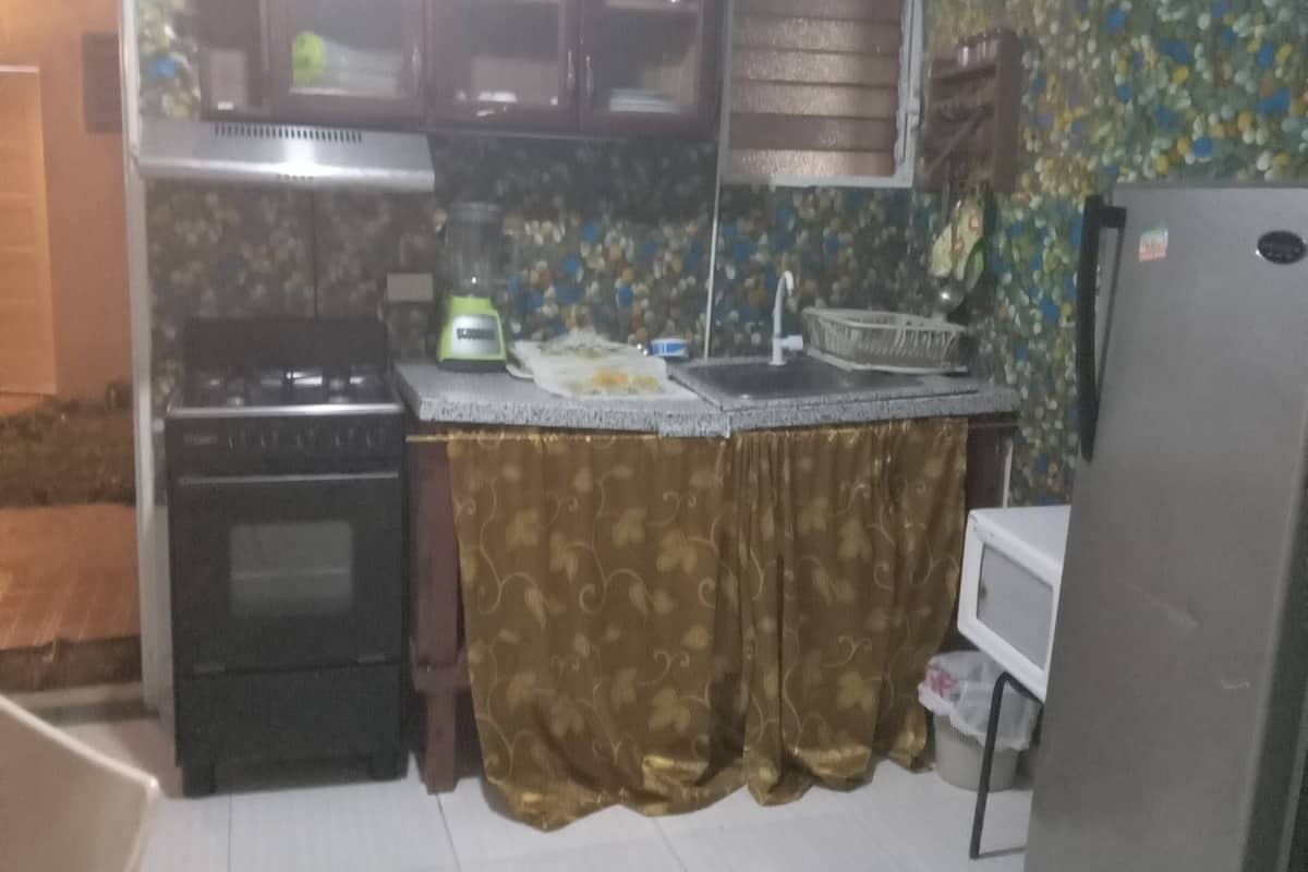 A compact kitchen with a stove, oven, and refrigerator.