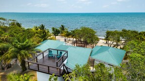 A resort with a beach view, wooden deck, and a gazebo. - Hidden Gem: 3-Bedroom Infinity Pool Villa on Beach (Placencia)