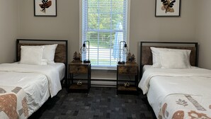 A hotel room with two beds, a window with blinds, and two nightstands with lamps. - The Hidden Oasis, Duplex A. Close to almost everything! (Enfield)