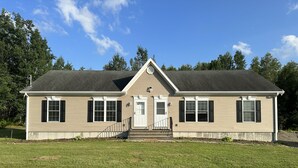 A single-story house with a front porch, a small staircase leading to the door, and a well-maintained lawn. - The Hidden Oasis, Duplex A. Close to almost everything! (Enfield)