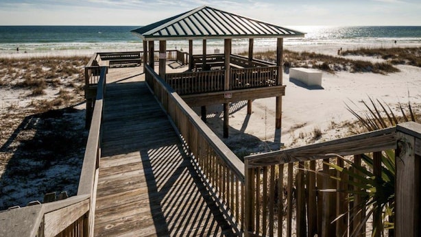 A wooden boardwalk leading to a beach gazebo with a metal roof. - Gulf Winds East 22 * Fall Specials * Across from beach * Salt Water Vacations (Destin)