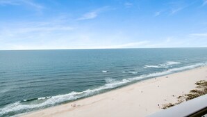 A beach with clear skies and calm waters. - Phoenix Gulf Tower 1704 | Spacious, luxurious, Newest OBA development! (Orange Beach)