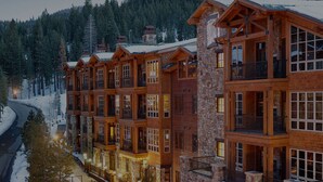 A multi-story lodge with stone and wood architecture, featuring balconies and large windows, surrounded by a snowy forest. - NorthStar Lodge at Lake Tahoe in walking distance to ski lifts! (Truckee)