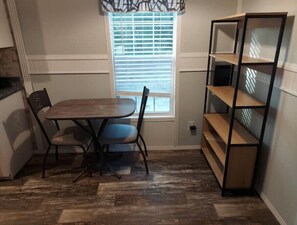 Cozy retreat with a dining table and shelving unit.