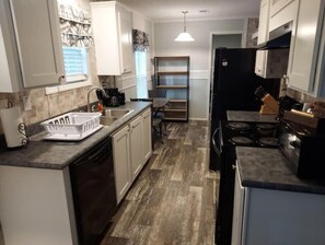 Enjoy cooking in this well-equipped kitchen with a central island, dishwasher, and four-burner stove.