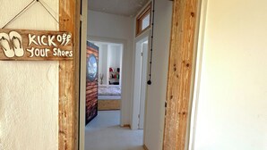 A hallway with a wooden door frame and a sign that reads "Kick off your shoes". - Studio Loft Filmatelier (Hamburg)