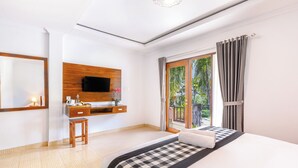 A hotel room with a bed, a desk, a TV, and a balcony with curtains. - Tinggian Hill Retreat (Penida Island)