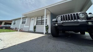 A house with a garage and a parked SUV. - Gorgeous 3Bed in the heart of South Florida (Fort Lauderdale)