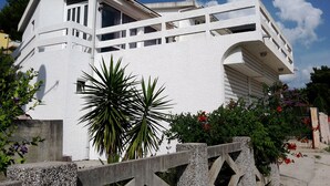 A modern white building with a balcony and a concrete fence. - The only apartment in a detached house (Bar)