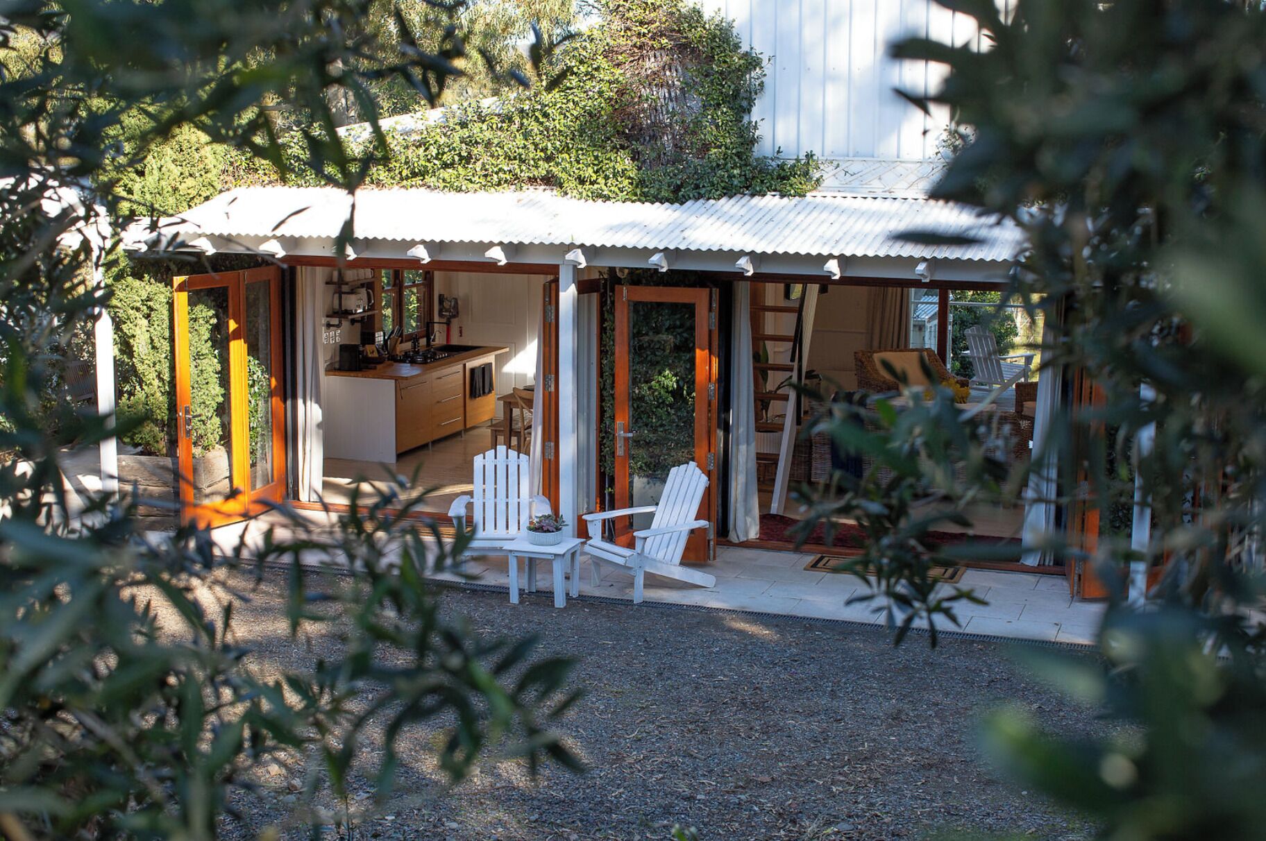 A house with a covered porch, a dining area, and a kitchen.
