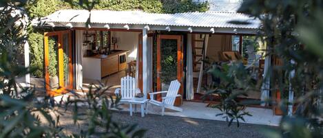 A house with a covered porch, a dining area, and a kitchen.