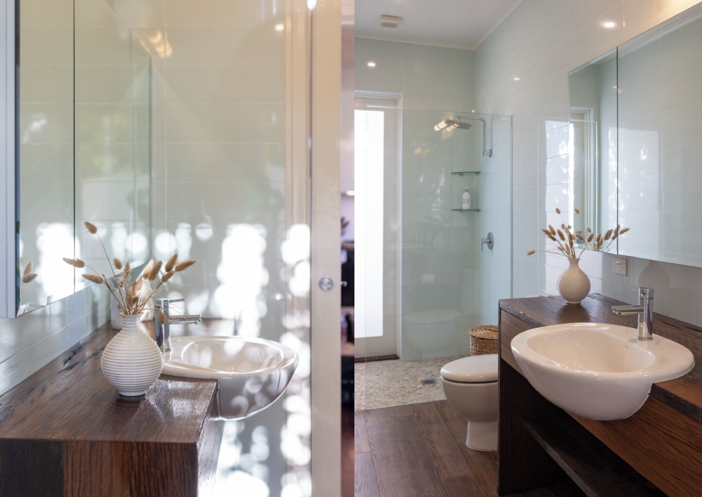 A modern bathroom with a large mirror, two sinks, and a shower.
