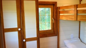 A wooden-paneled room with a bunk bed, a sliding door, and a window. - Roulottes a la Ferme sur le Plateau du Vercors (Autrans-Méaudre en Vercors)