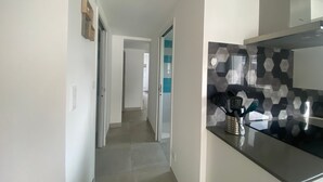A modern kitchen with a black and white hexagonal backsplash, a stainless steel countertop, and a black and white patterned tile floor. - New Downtown House w/ Garden, Parking, WIFI & A/C - 500m to Beach (La Tranche-sur-Mer)