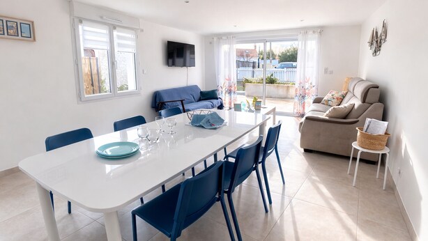 A modern living space with a dining area, a sofa, and a television. - New Downtown House w/ Garden, Parking, WIFI & A/C - 500m to Beach (La Tranche-sur-Mer)