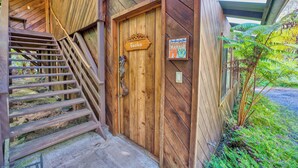 A wooden staircase leading to a door labeled "Gecko." - The Pacifica Inn/ 
The Gecko Room (Volcano)