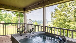 A hot tub on a wooden deck with a view of a house and trees. - Serene Cabin, Sleeps 12 W Views・Hot tub・Games (Sevierville)