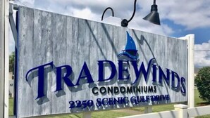A sign for TradeWinds Condominiums, located at 2250 Scenic Gulfview. - Tradewinds 24 * Across from the beach * Fall Rates * Salt Water Vacations (Miramar Beach)