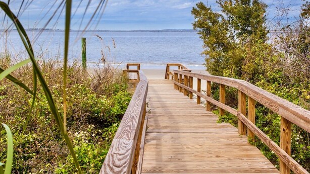 A wooden boardwalk leading to a beach with a clear view of the ocean. - Breezy Palms on the Bay!  Dolphins, Pools, Beach (Tybee Island)
