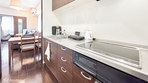 A modern kitchen with a dishwasher, a kettle, and a coffee maker. - Near Tsutenkaku, Toy Street, Spacious,Elevator,Wi-Fi,Self check-in, Easy Transit (Osaka)