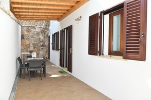 Enjoy a peaceful retreat in this serene patio area with a table and chairs.