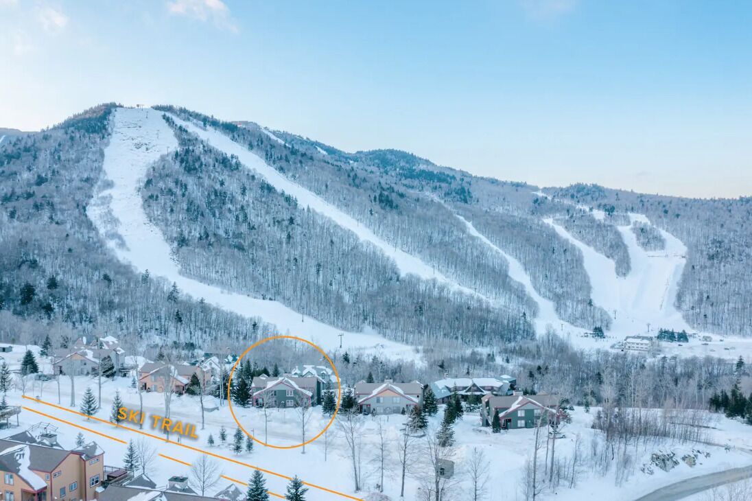 A ski trail with a residential area in the foreground.